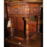 A good early 20th century floral relief carved and joined oak single door credence table, raised