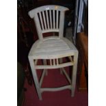 A set of three contemporary faded teak slatback bar stools