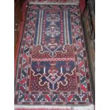 A Turkish woollen prayer rug, 150 x 78cm, together with a Persian style machine woven red ground
