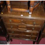 A 1920s geometric moulded oak chest of four long drawers, raised on squat bobbin supports, width