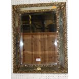 An early 20th century embossed brass applied bevelled rectangular wall mirror, 56.5 x 44.5cm