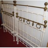 A pair of Victorian style cream painted wrought iron and brass single bedsteads (each with side