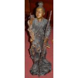 A large bronze figure, modelled as a Japanese fisherman, standing dressed in floral decorated robes,
