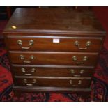 A contemporary mahogany table top chest of four long drawers, having end carry handles, width 56.