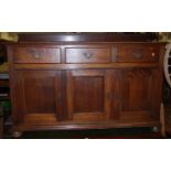 An early 20th century oak ledgeback three-door sideboard, having three frieze drawers, w.153cm