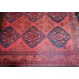A Persian woollen red ground rug, 190 x 151cm