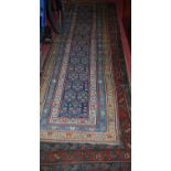 Two Persian woollen blue ground hall runners, each with floral central ground within trailing