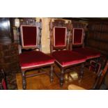 A set of six late Victorian mahogany and floral relief carved pad back and seat dining chairs