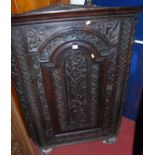 A 19th century floral relief carved oak hanging single door corner cupboard, width 92.5cm