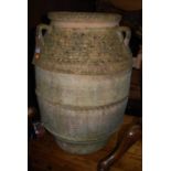 A large terracotta three handled olive jar, of ovoid form, h.70cmCondition report: One major crack