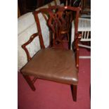 A Chippendale style mahogany single elbow chair, having a tan leather upholstered stuff over seat on