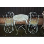 A contemporary painted wrought metal French style garden suite to include; circular table and set of