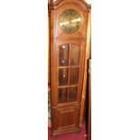 A contemporary Belgian oak freestanding corner clock having glazed trunk door, height 207cm