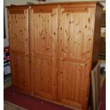 A modern pine three door wardrobe, w.193cm