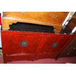 A Chinese red and black lacquered low four door side cupboard, width 124cm