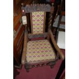 An early 20th century relief carved oak barley twist single elbow chair, together with a rexine