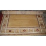 A contemporary European machine woven beige ground classical style rug