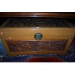 An Eastern relief carved camphor wood hinge topped blanket box, w.101cm