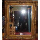 A large contemporary floral gilt framed bevelled rectangular wall mirror, 160 x 129cm