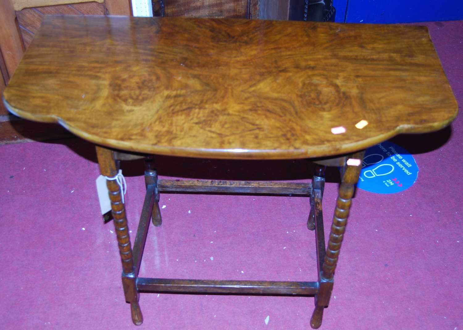 An early 20th century walnut shaped top bobbin turned side table, width 92cm