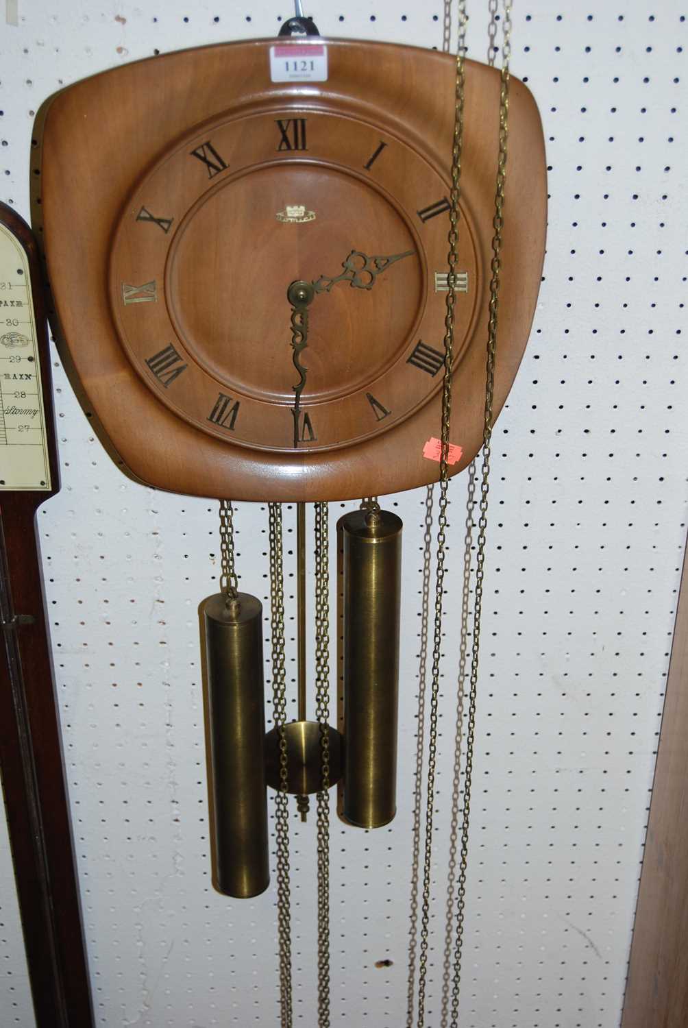 A 1950s walnut hanging open wall clock, having pendulum and two weights