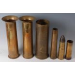 A pair of WW I 12-pounder shells, each dated 1916, together with a pom pom artillery shell,