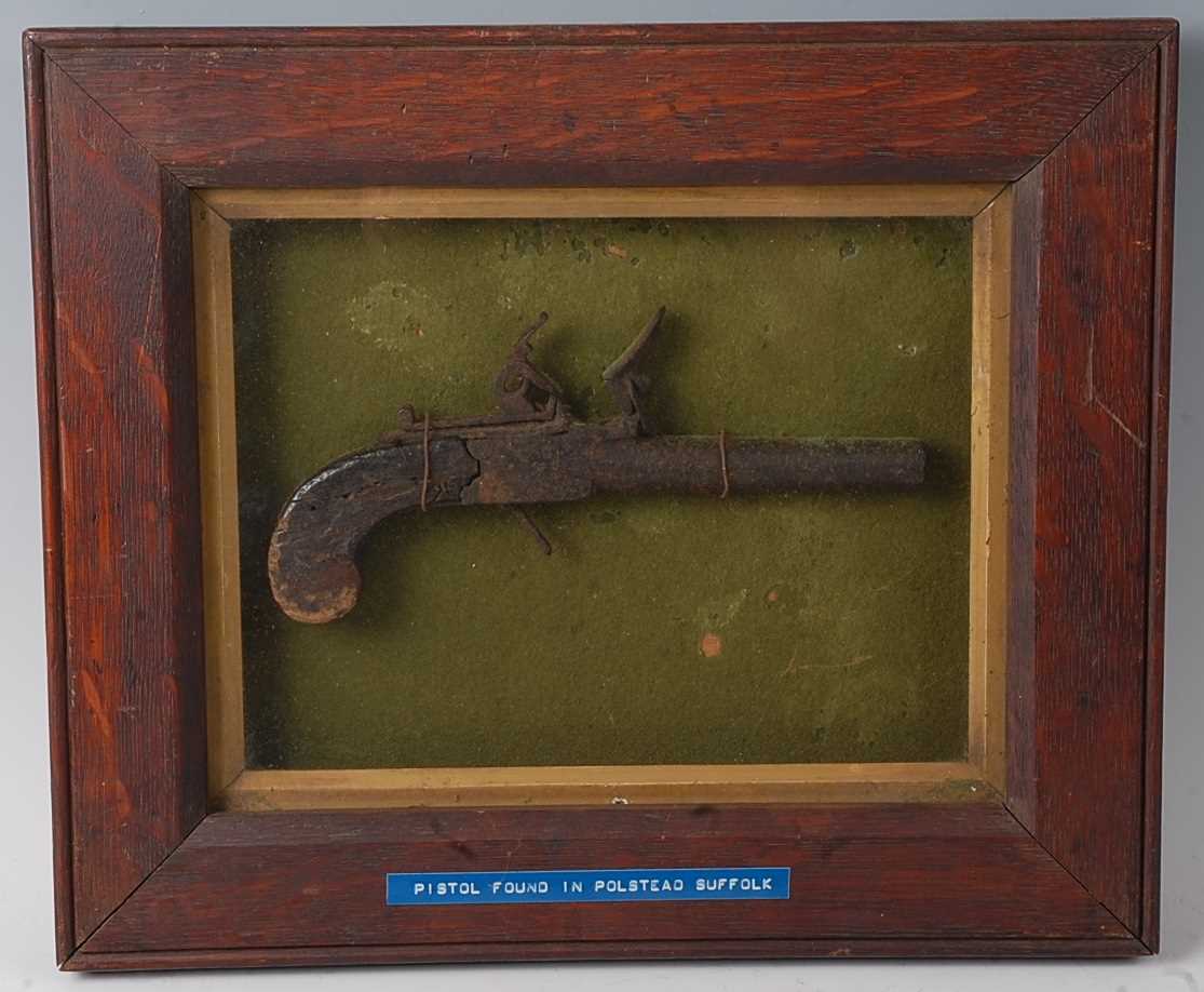 A 19th century flintlock box lock pocket pistol, the lock plate marked London, housed in an oak