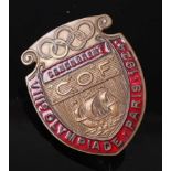 A 1924 Paris Olympic gilt metal and red enamelled competitors badge of shield shape, having a