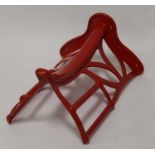 * A 19th century and later red painted iron saddle rack, stamped Musgraves Patent, Belfast & London,