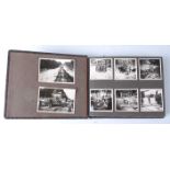 A post WW II photograph album, the black and white contents mainly showing a group of soldiers on