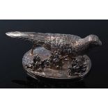 An early 20th century Continental silver menu holder in the form of a grouse on a naturalistic base,