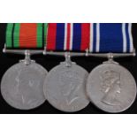 A group of three medals to include WW II Defence, War and E.R. II Police Exemplary Service medal,