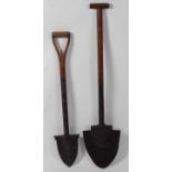 * An early 20th century peat spade, having a shaped blade and D handle with indistinct makers mark