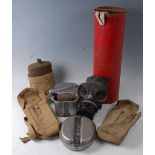 A WW II British civilian gas mask, dated 1940, together with two webbing pouches and canteens etc.