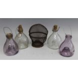 * A pair of early 20th century purple tinted glass fly traps, of pear shape, h.13cm; together with a
