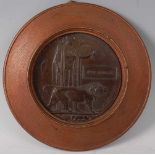 A WW I bronze memorial plaque, naming Jesse Pearson, mounted in an oak surround, dia. 20cm.