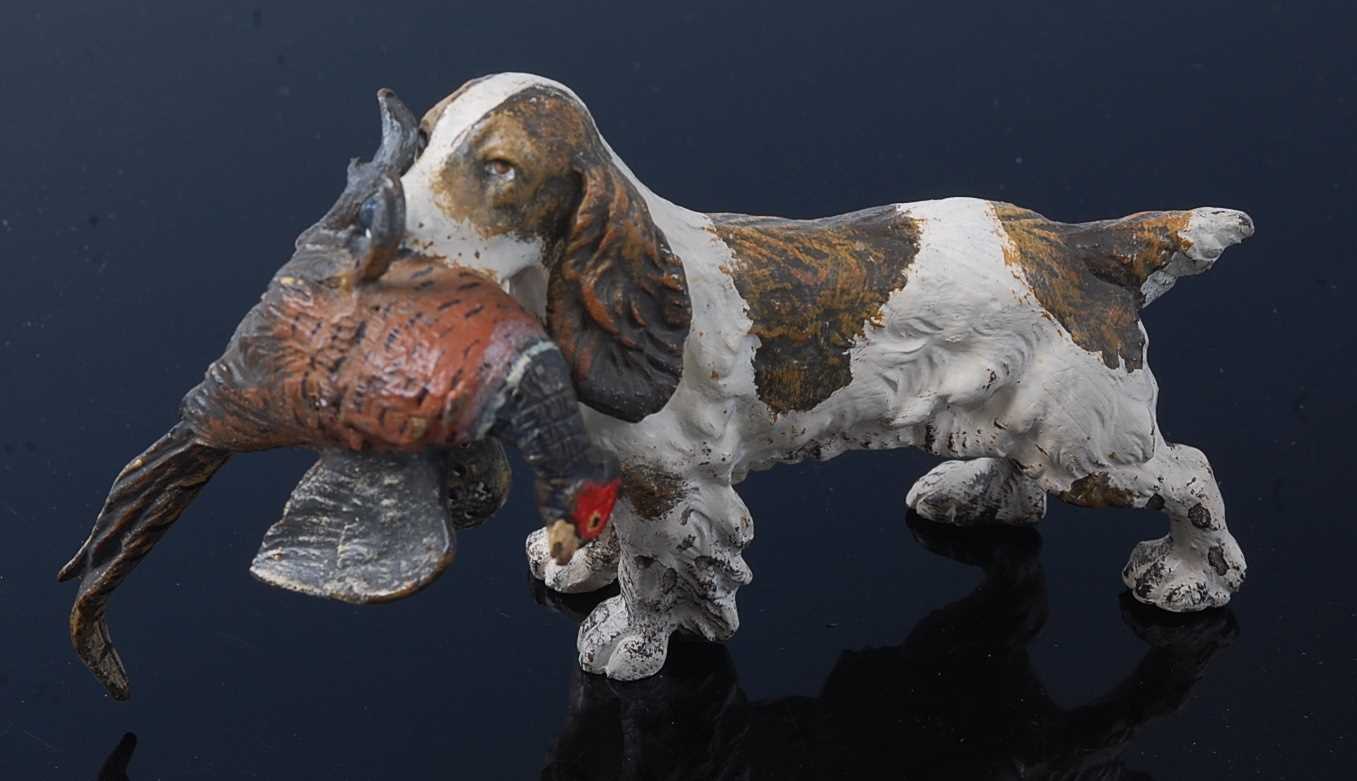 An early 20th century cold painted bronze figure of a spaniel with a pheasant in its jaws, L.13cm.