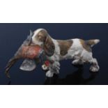 An early 20th century cold painted bronze figure of a spaniel with a pheasant in its jaws, L.13cm.