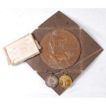A WW I Casualty group to include a bronze memorial plaque, naming George Fletcher, in envelope