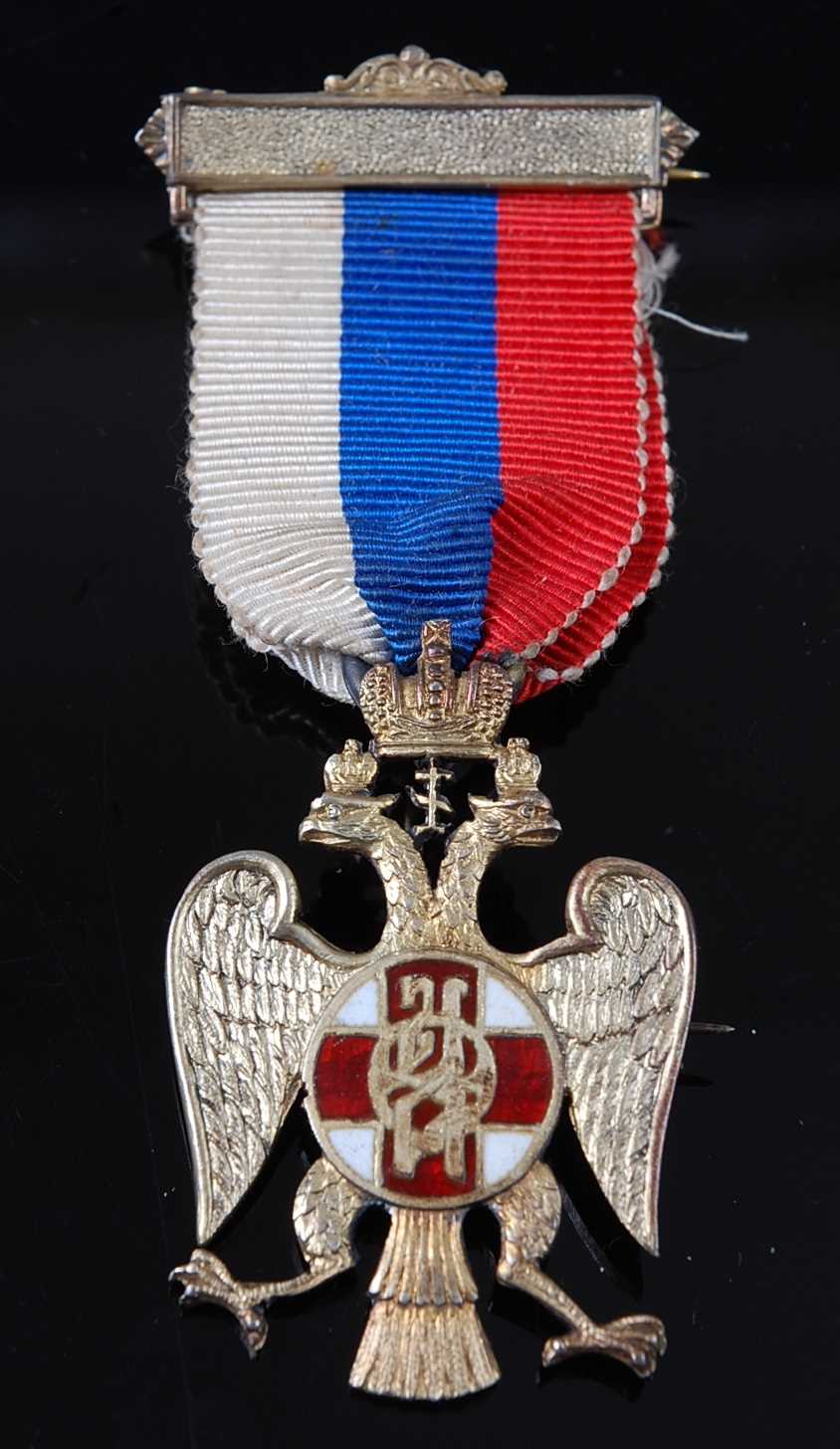 An English made silver and enamelled badge for the Russian Flag Day Movement, in the form of an