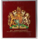 A large perspex panel, transfer printed with the Royal Coat of Arms and By Appointment To Her