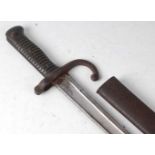 A French Model 1866 chassepot bayonet, the 57cm single edged fullered Yataghan shaped blade engraved