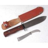 * A Wilkinson hunting knife, having an 18cm blade and two piece walnut grip, housed in a leather