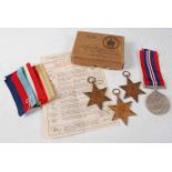 A group of four WW II medals, to include 1939-1945 Star, Italy Star, Africa Star, and War medal,