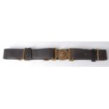 A British Army black leather belt, the brass buckle with a lion above a crown within legend Dieu