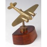 A brass model of a Bristol Beaufighter aeroplane, mounted on a spent shell and part propeller boss