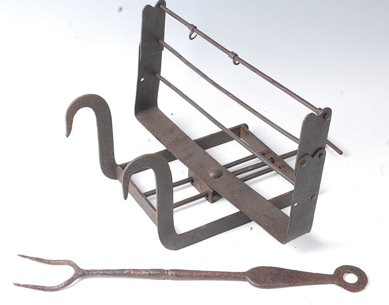 * An 18th century wrought iron lark spit, having an adjustable rotating grill for three birds, 44cm,