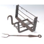 * An 18th century wrought iron lark spit, having an adjustable rotating grill for three birds, 44cm,