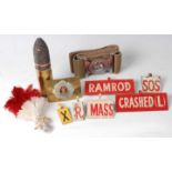 A collection of miscellaneous militaria to include a German WW I 37mm shell, a Royal Scots brass