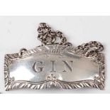 A George III silver decanter label for Gin, with chain, maker Hester Bateman, no date letter struck,